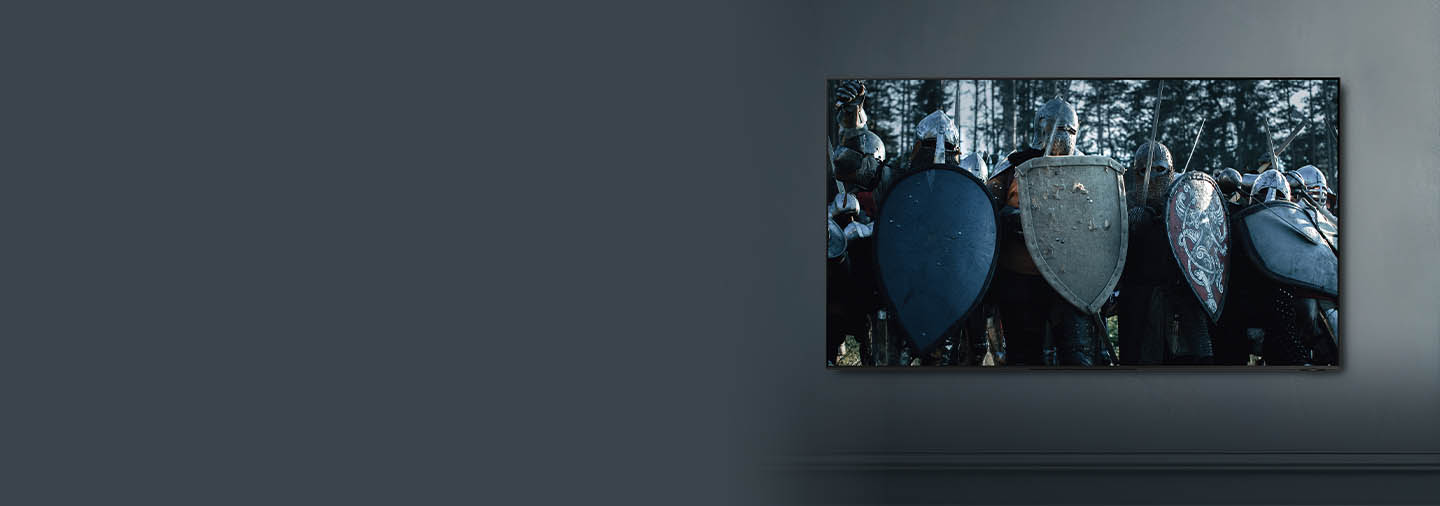 TV mounted on wall showing medieval warriors