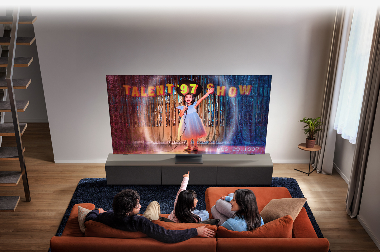 Family watching 'Talent '97 Show' on TV