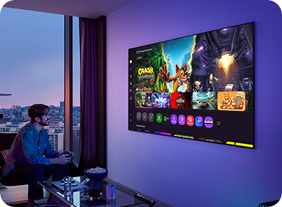 Man playing video games on TV in dark room